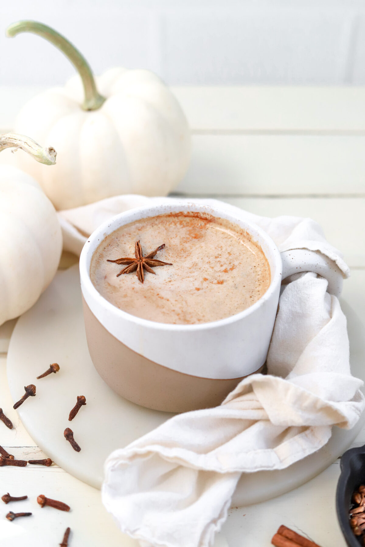 Pumpkin Spice Oat Milk Latte ready to drink with fall decor on table