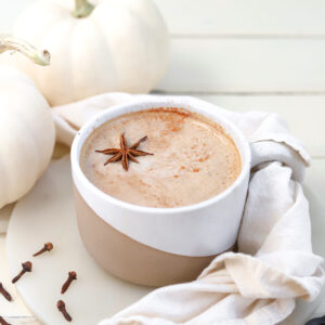 Pumpkin Spice Oat Milk Latte ready to drink with fall decor on table