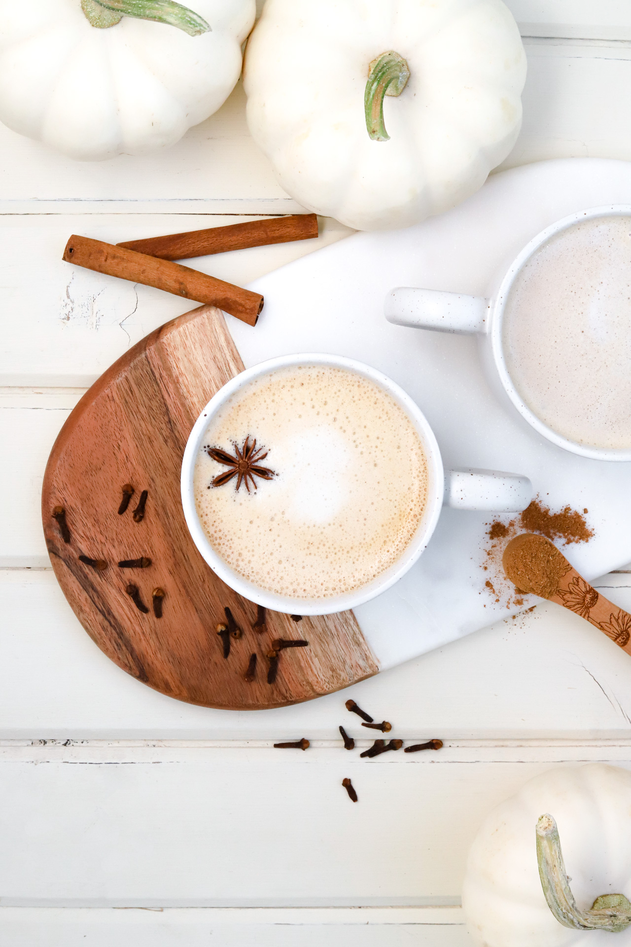 Pumpkin Spice Oat Milk Latte with pumpkins and spices, overhead shot