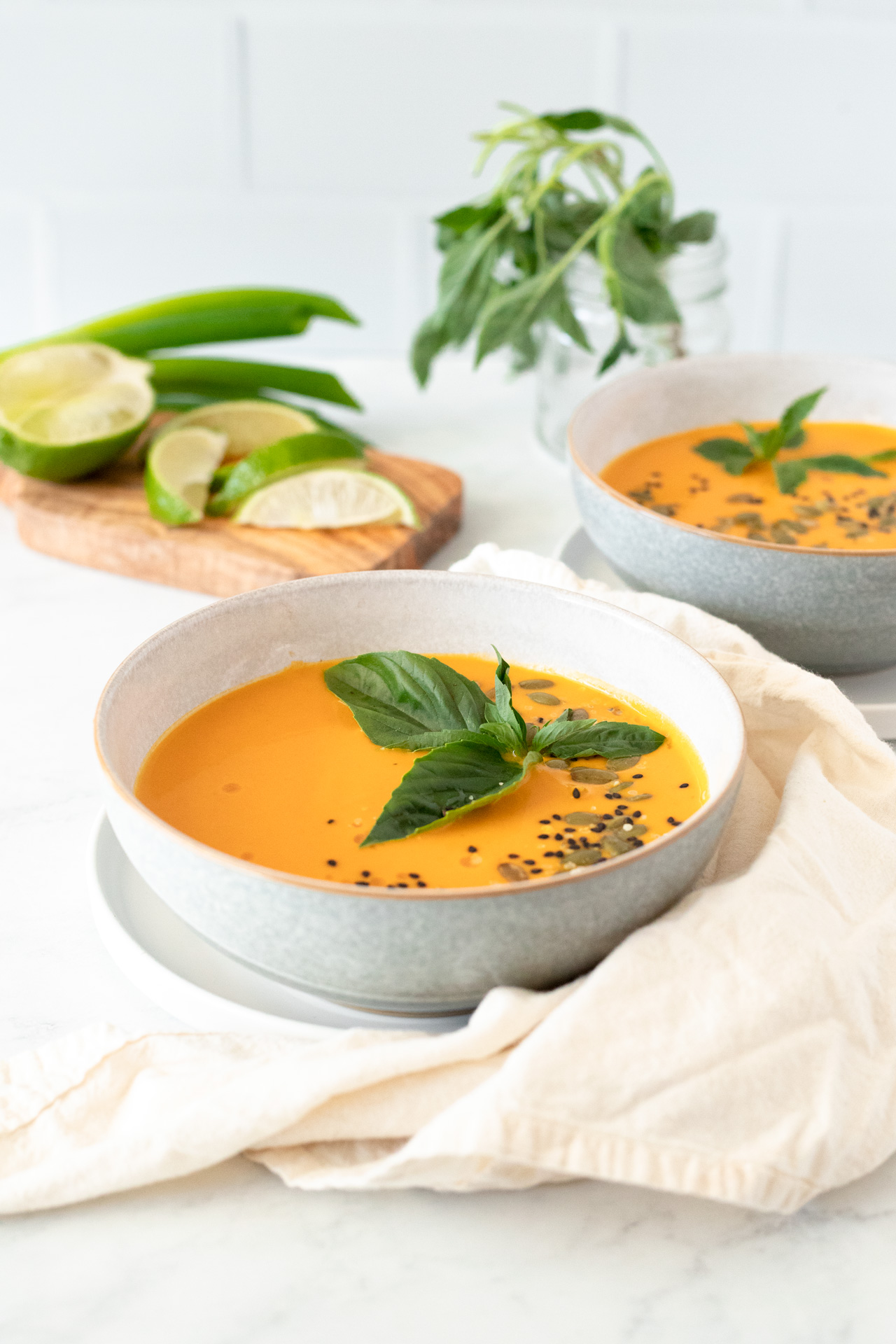 Roasted Butternut Squash Coconut Curry Soup on a table for two