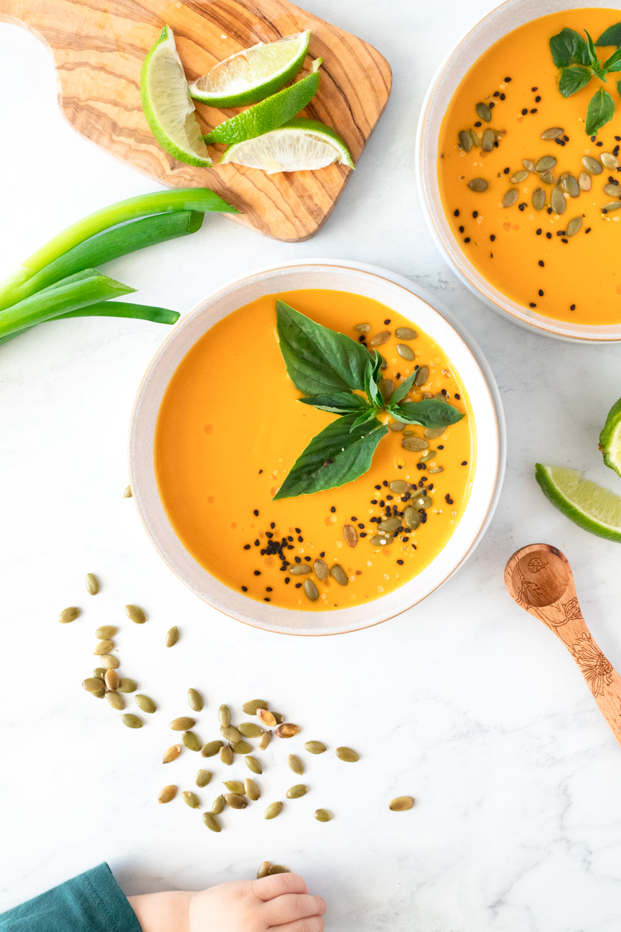 Roasted Butternut Squash Coconut Curry Soup with child's hand