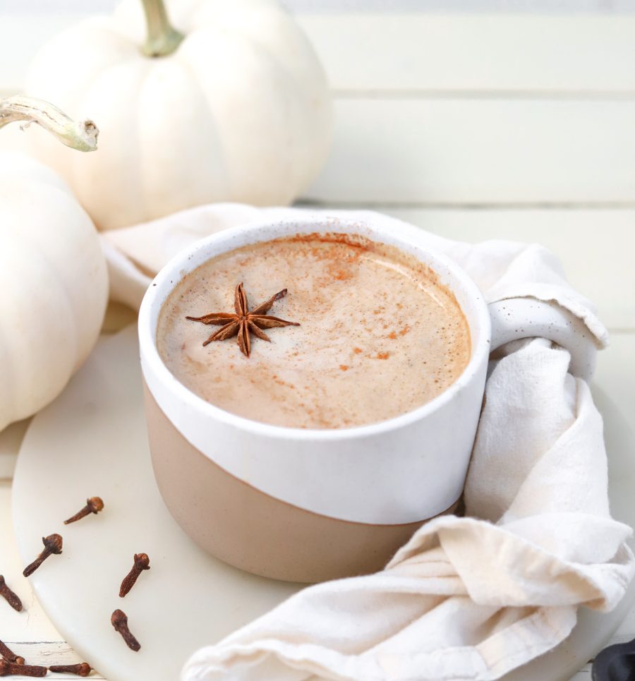 Pumpkin Spice Oat Milk Latte ready to drink with fall decor on table